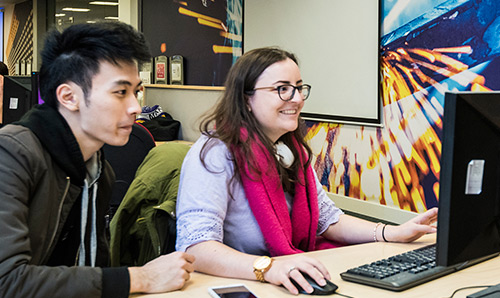 Student and mentor looking at something on a screen